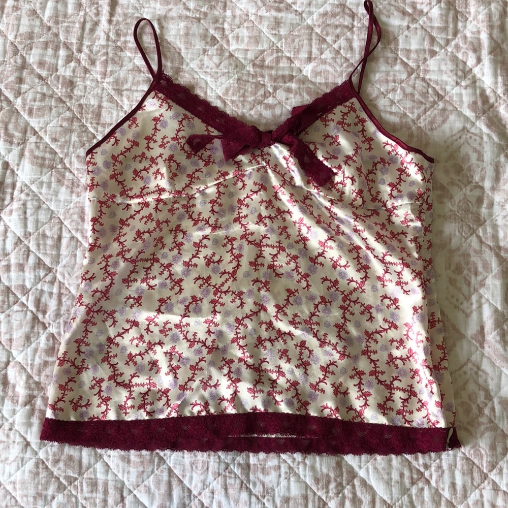 Satan spaghetti strap top with lace trims.